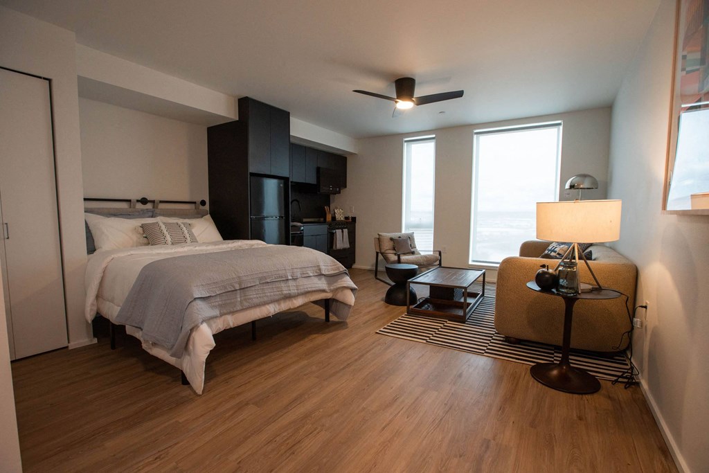 a bedroom with a bed and a couch and a window at Analog Tacoma, Tacoma, 98402