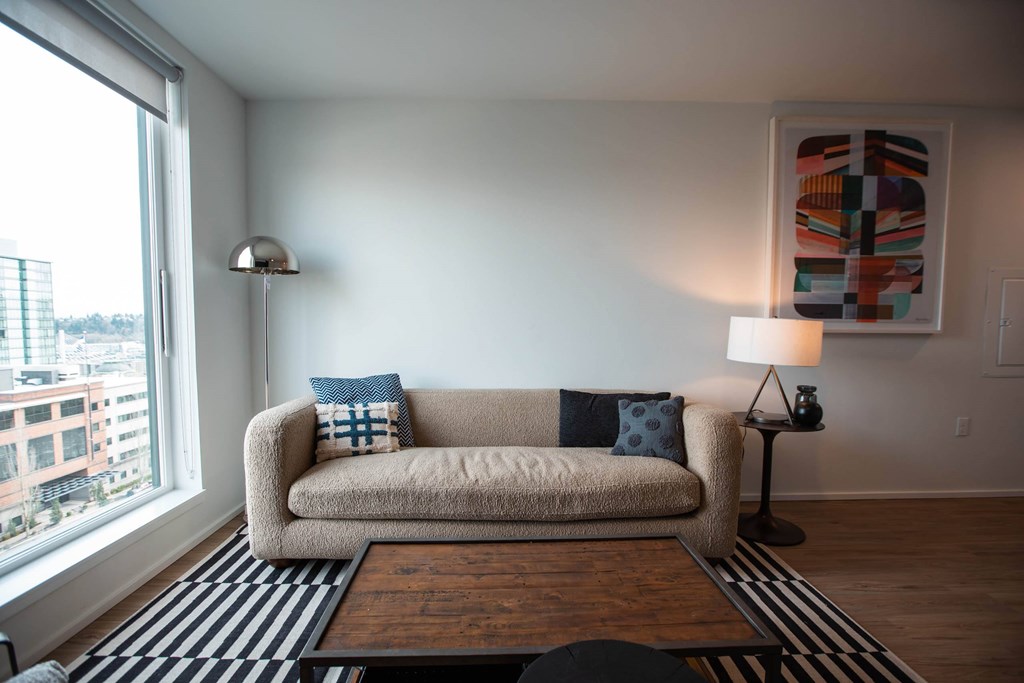 a living room with a couch and a large window at Analog Tacoma, Tacoma, WA, 98402