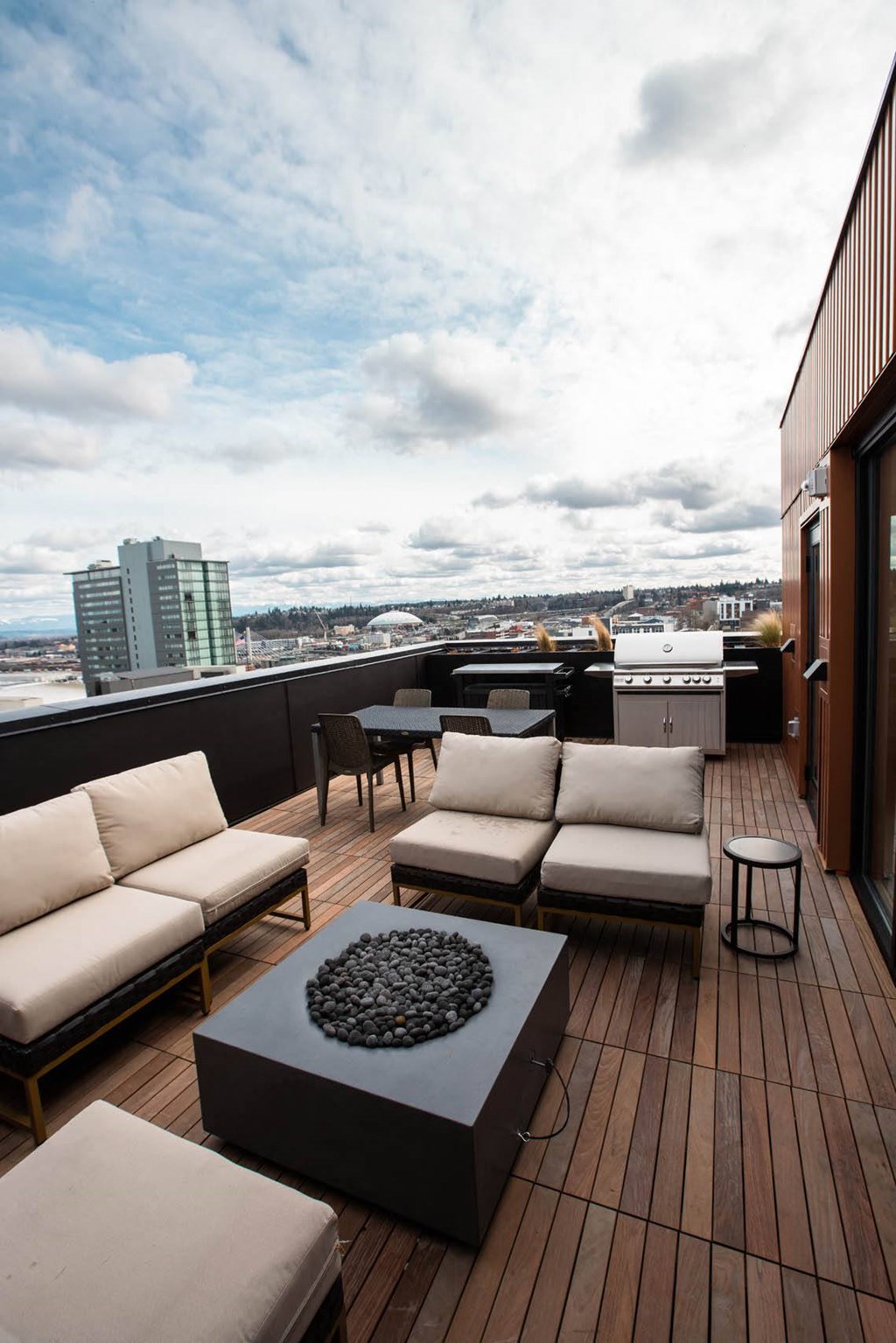 a rooftop deck with couches and a table at Analog Tacoma, Washington 98402
