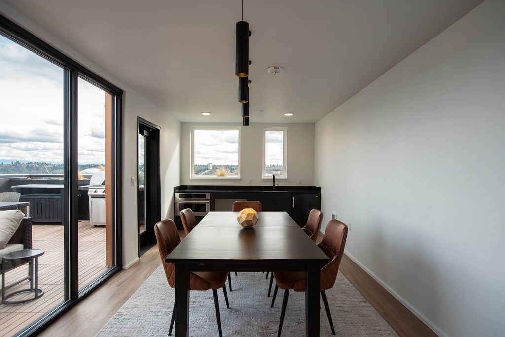 a dining room with a table and chairs and sliding glass doors a dining room with a table and chairs and sliding glass doors at Analog Tacoma, Tacoma, WA