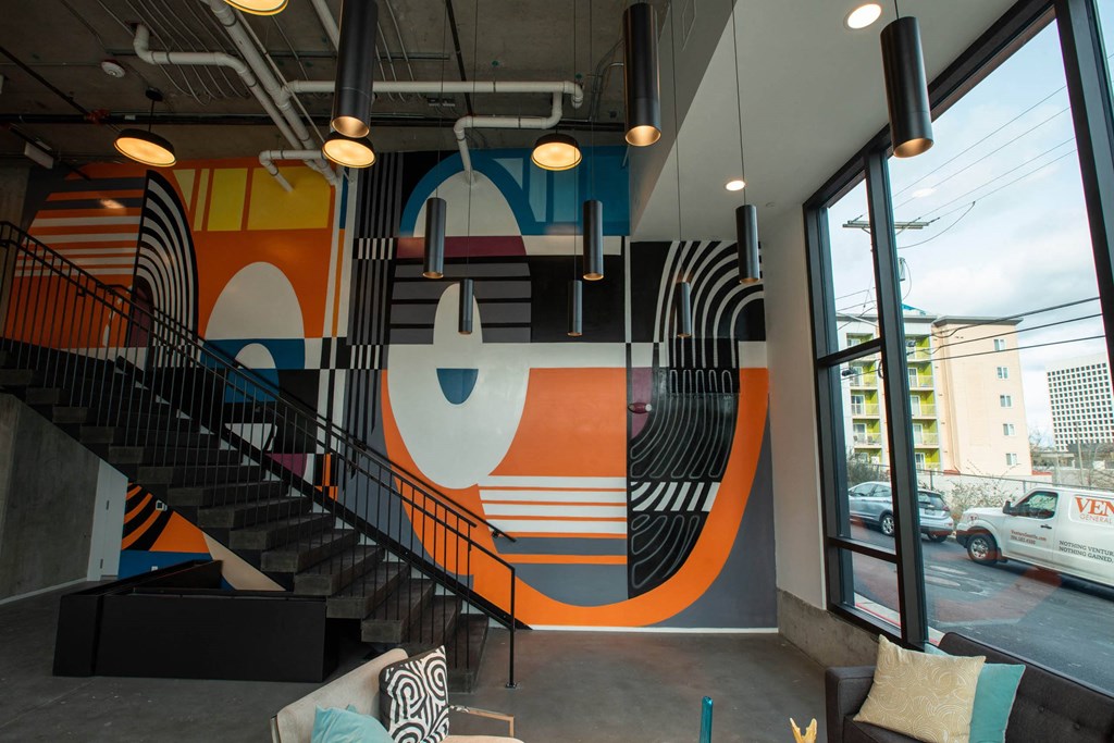 a mural in the lobby of a building with a staircase at Analog Tacoma, Tacoma, 98402