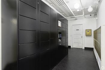 a row of black lockers in a room with a door at Clay & Tiffany, Portland, 97201
