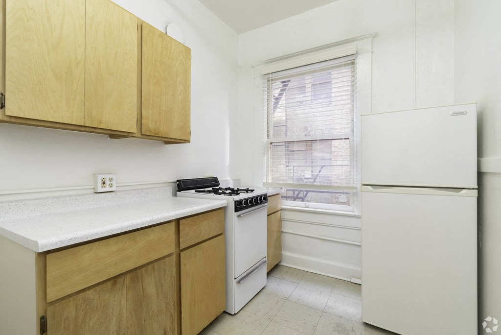 a kitchen with white appliances and wooden cabinets at Clay & Tiffany, Portland, OR, 97201