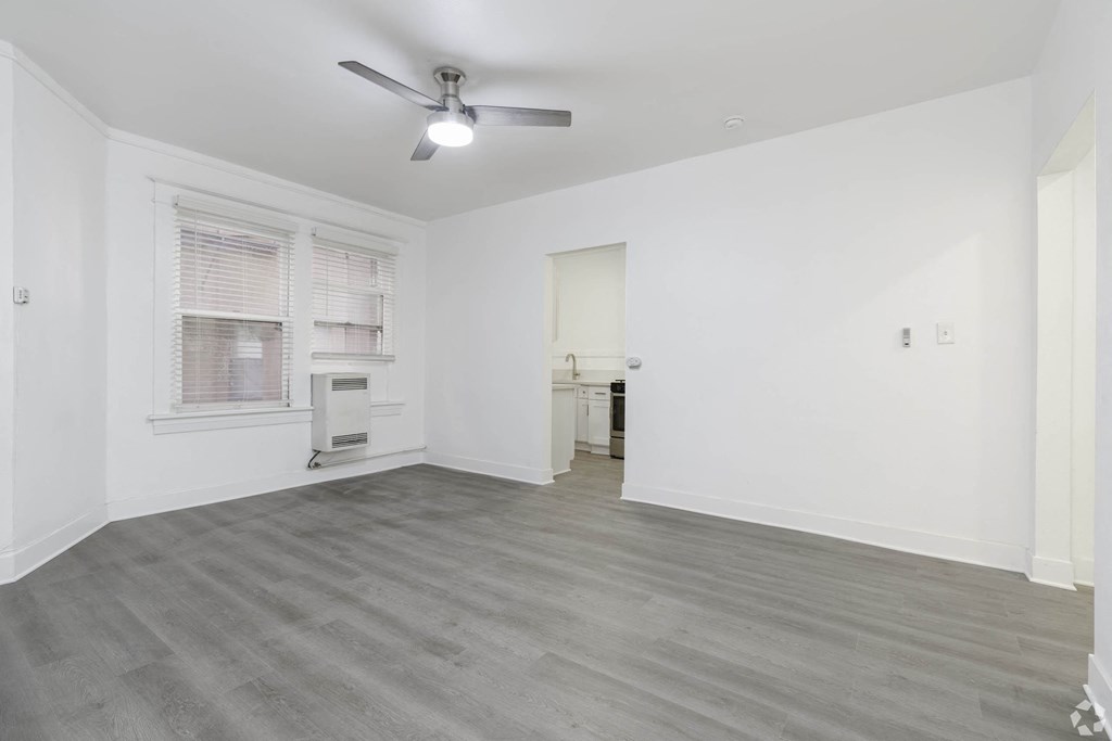 an empty living room with a ceiling fan and a window at Clay & Tiffany, Portland, 97201