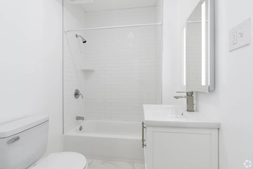 a white bathroom with a tub and a sink and a toilet at Clay & Tiffany, Portland, OR, 97201