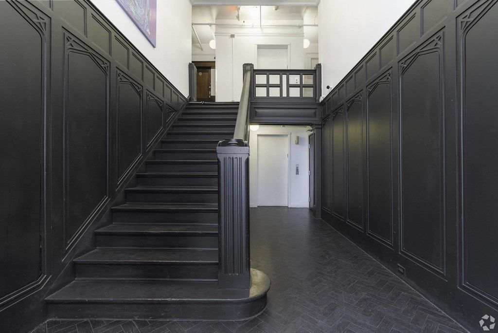 the lobby of a building with a staircase and black doors the lobby of a building with a staircase and black doors at Clay & Tiffany, Portland, 97201