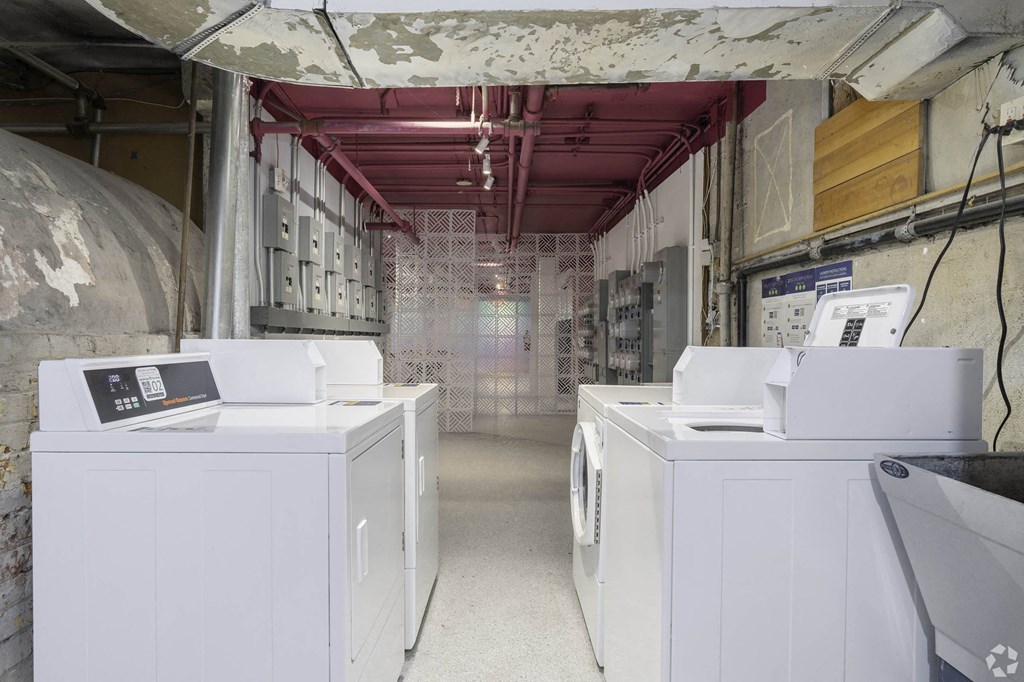 a laundry room with four washing machines in it at Clay & Tiffany, Portland, 97201