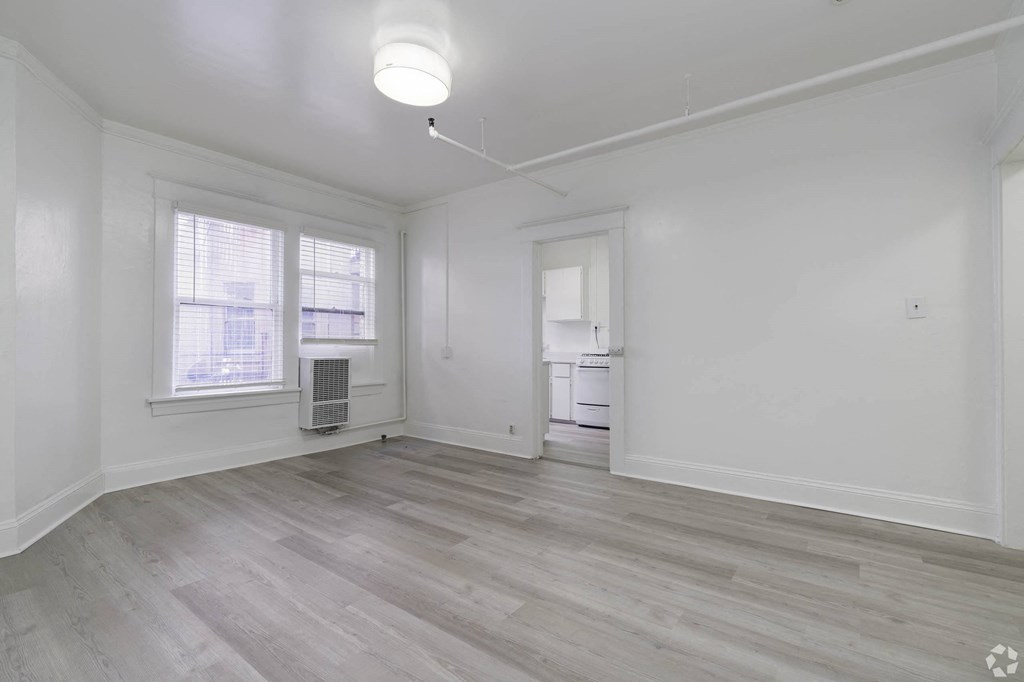 an empty living room with white walls and a window at Clay & Tiffany, Portland, OR, 97201