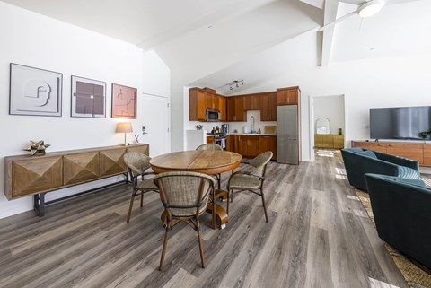 A modern dining room with a wooden table and chairs.