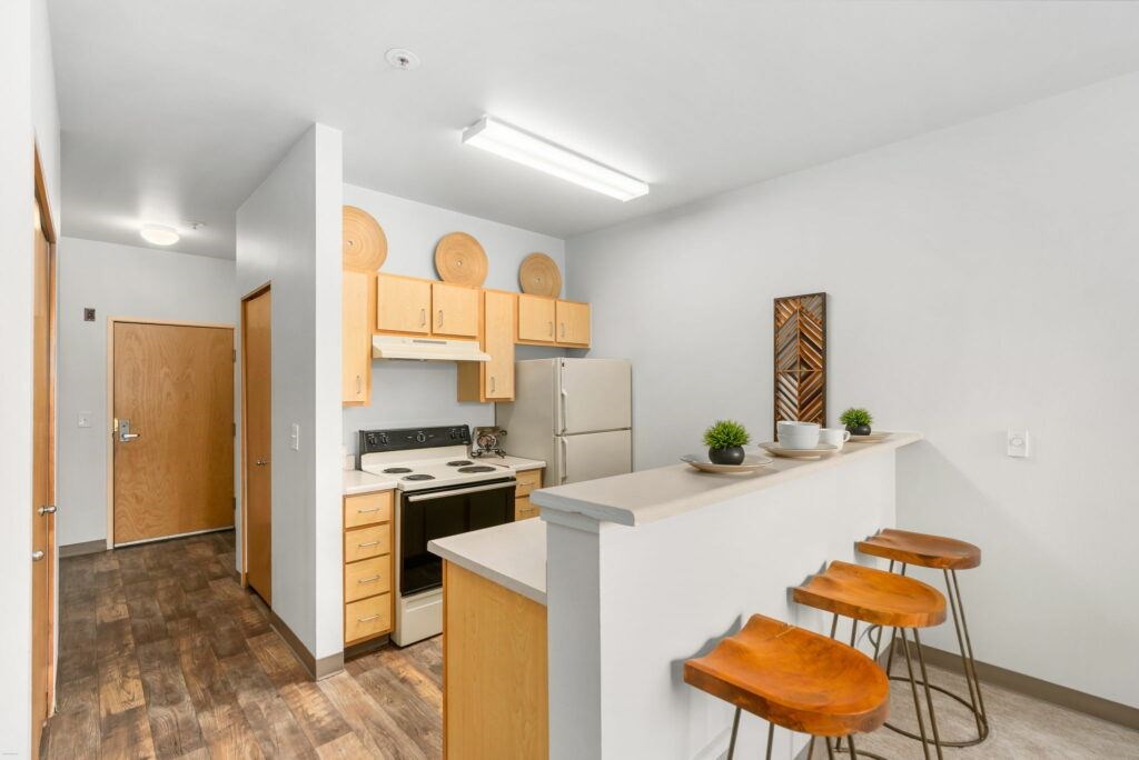 A kitchen with wooden floors and furniture.at Fifth Avenue Place Apartments, Portland, 97209