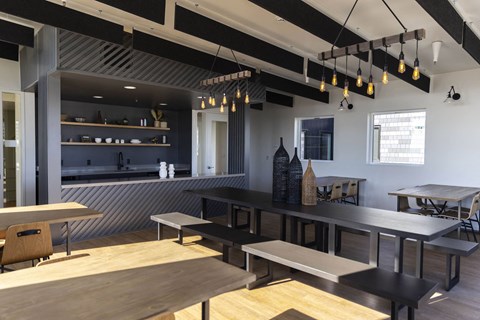 a dining room with tables and benches and a kitchen in the background at Moraine, Tacoma, Washington 98402