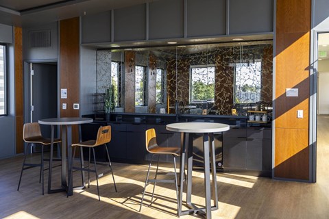a dining area with tables and chairs in a lobby at Moraine, Tacoma, WA 98402