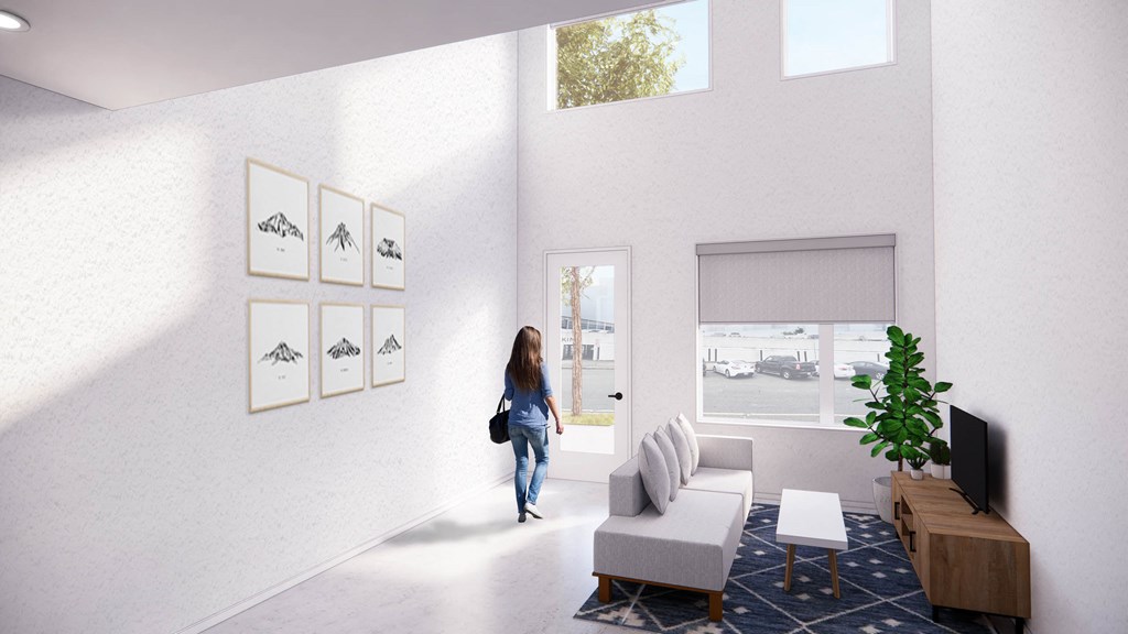 a woman walking into a living room with a couch and a window at Moraine, Washington, 98402