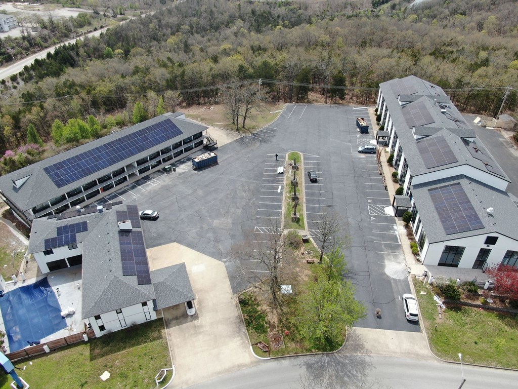 an aerial view of a building with solar panels on the roof at Schaefer Ridge Apartments, Branson , MO