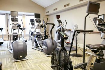 a gym with various exercise equipment in a room at Schaefer Ridge Apartments, Branson