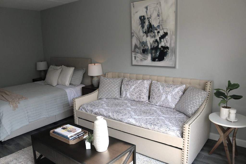 a living room with a couch and a bed a living room with a couch and a bed at Schaefer Ridge Apartments, Branson ,Missouri, 65616q