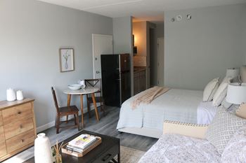 a bedroom with a bed and a couch and a table at Schaefer Ridge Apartments, Missouri