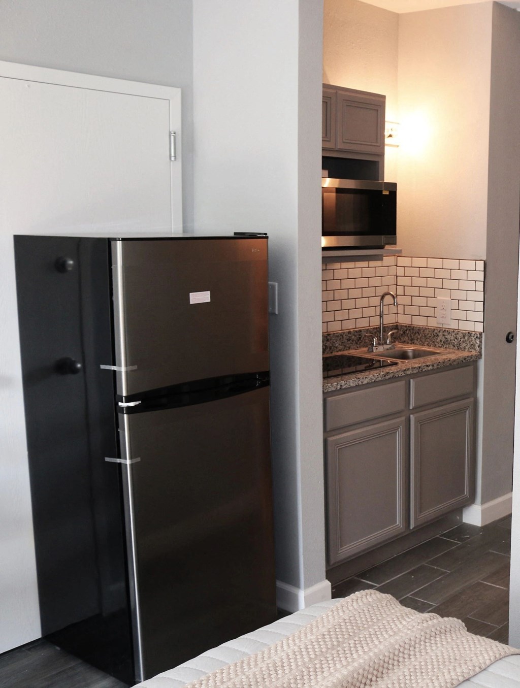 a small kitchen with a refrigerator and a sink a small kitchen with a refrigerator and a sink at Schaefer Ridge Apartments, Missouri