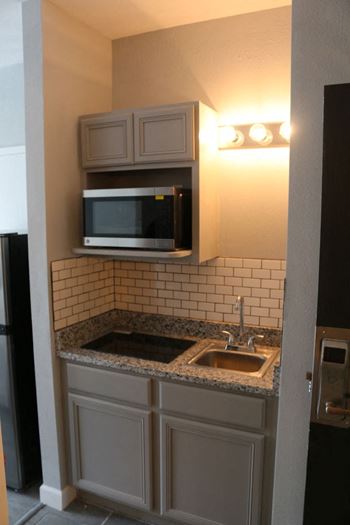 a small kitchen with a sink and a microwave at Schaefer Ridge Apartments, Branson ,Missouri, 65616
