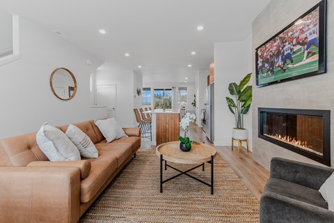 Living room with a fireplace and a television at Thrive at Green Mountain, Camas