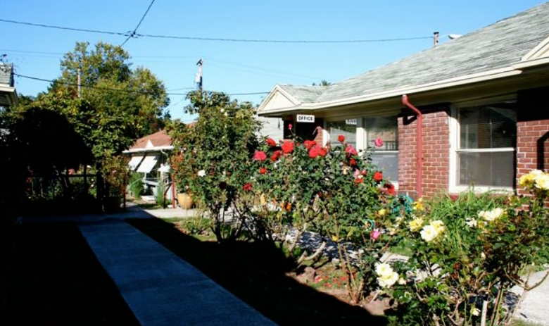 a house with roses in the front yard