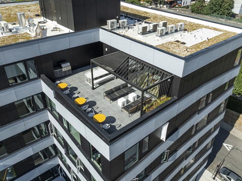 a large building with a rooftop terrace on top of it at Analog PDX Apartments, Oregon 97227