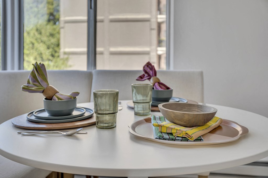 a white table with plates and bowls on it