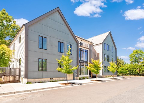 A modern house with a grey exterior and a black gate at Society 62 Apartments, Portland, Oregon
