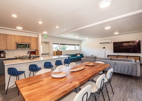 A modern kitchen with a dining table and chairs.