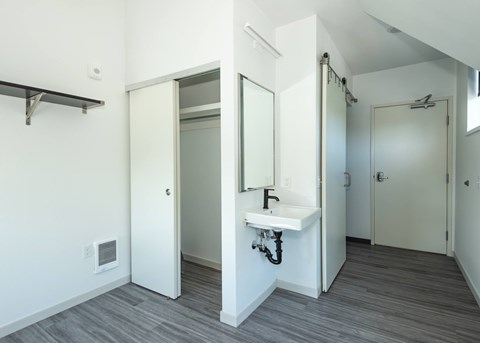 A bathroom with a sink and mirror at Society 62 Apartments, Portland, OR