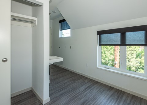 A room with a window and a bench. at Society 62 Apartments, Portland, OR, 97213