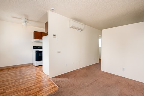 A kitchen with a white oven and a fan on the ceiling.