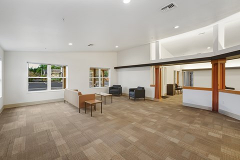 A spacious room with a carpeted floor and a few pieces of furniture.
