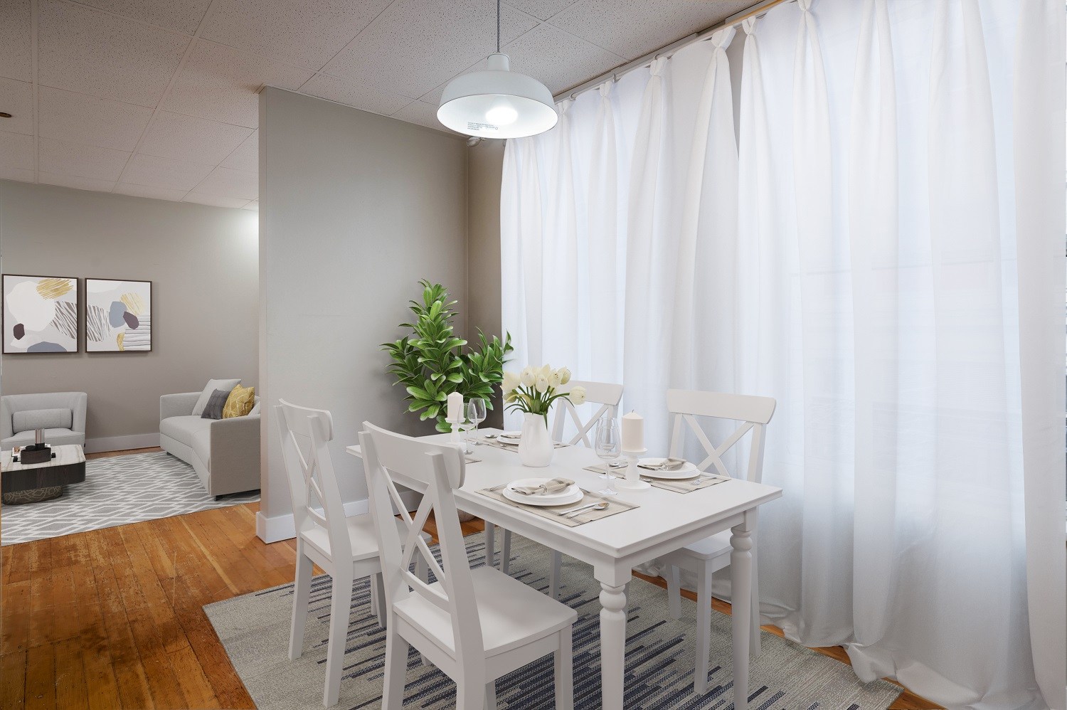 A dining room with a white table and chairs.