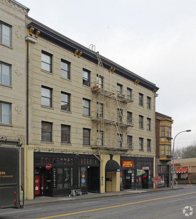 a large brick building with a fire escape on a city street