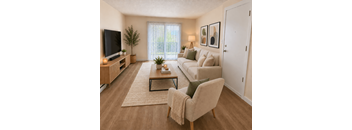 A living room with a couch, chair, and television.