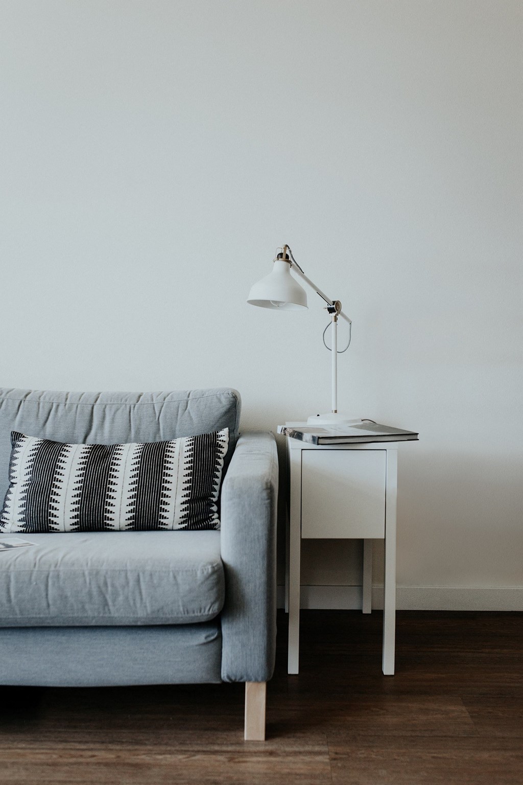 a living room with a couch and a lamp