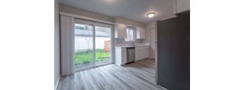 an empty kitchen with a sliding glass door