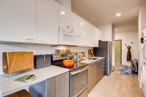 a kitchen with stainless steel appliances and white cabinets
