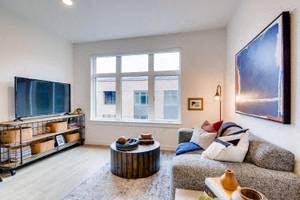 a living room filled with furniture and a flat screen tv