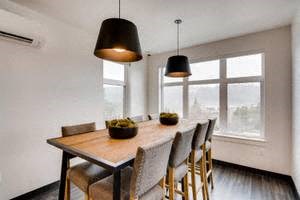 a dining room with a wooden table and chairs