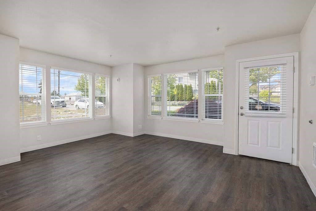 an empty living room with white walls and a white door