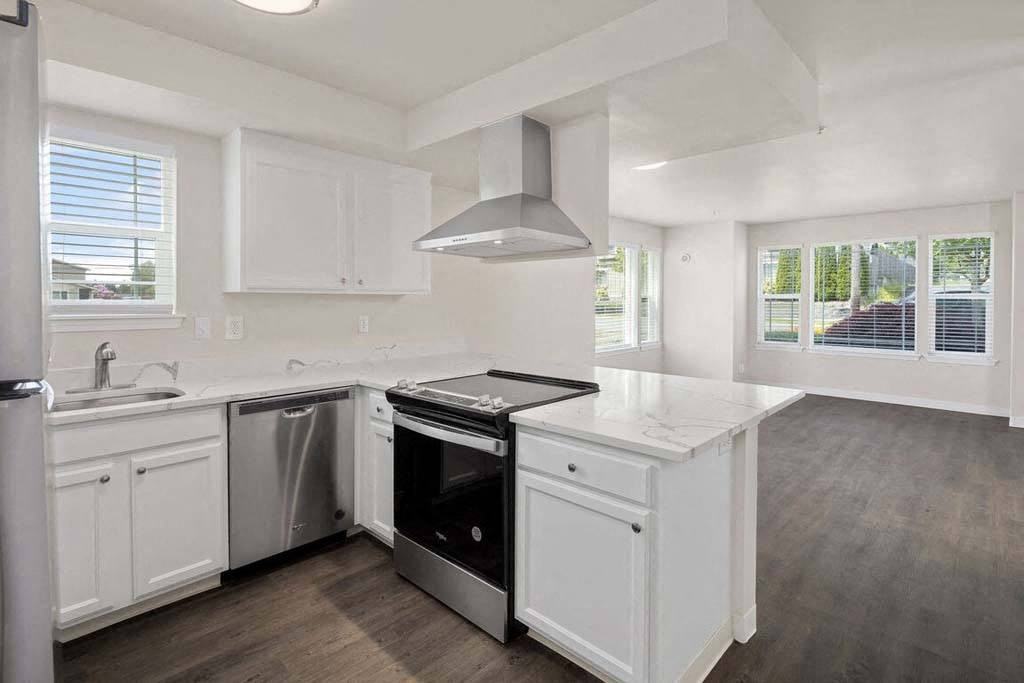 a kitchen with a stove top oven next to a sink