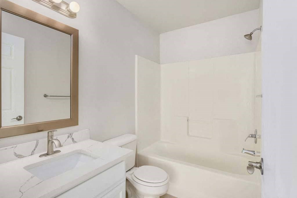 a bathroom with a sink toilet and bathtub