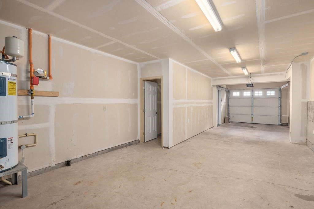 a large room with white walls and a door