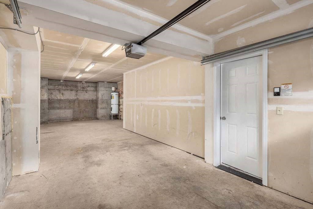a garage with a white door and white walls