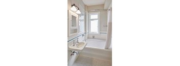 a bathroom with a sink bathtub and mirror