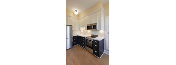 a kitchen with a stove a refrigerator and a microwave
