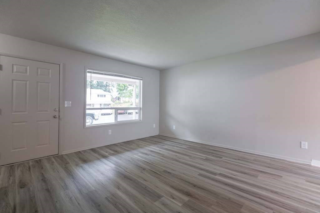 an empty room with a door and a window