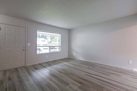 an empty room with a door and a window